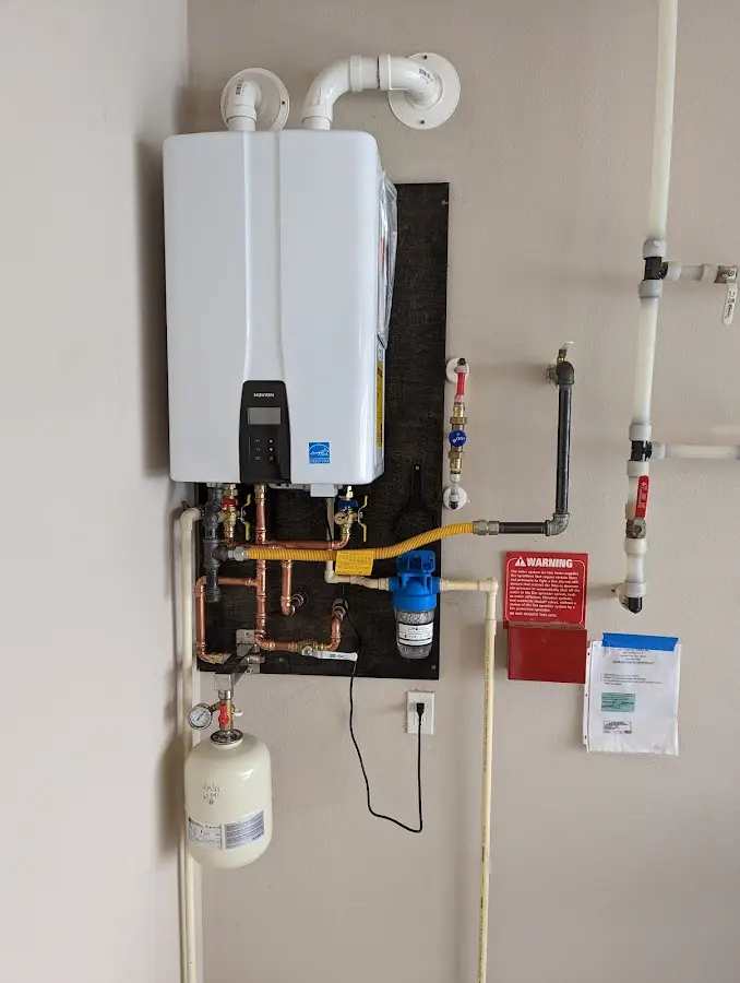 Professional plumber installing copper piping in a Claremont home